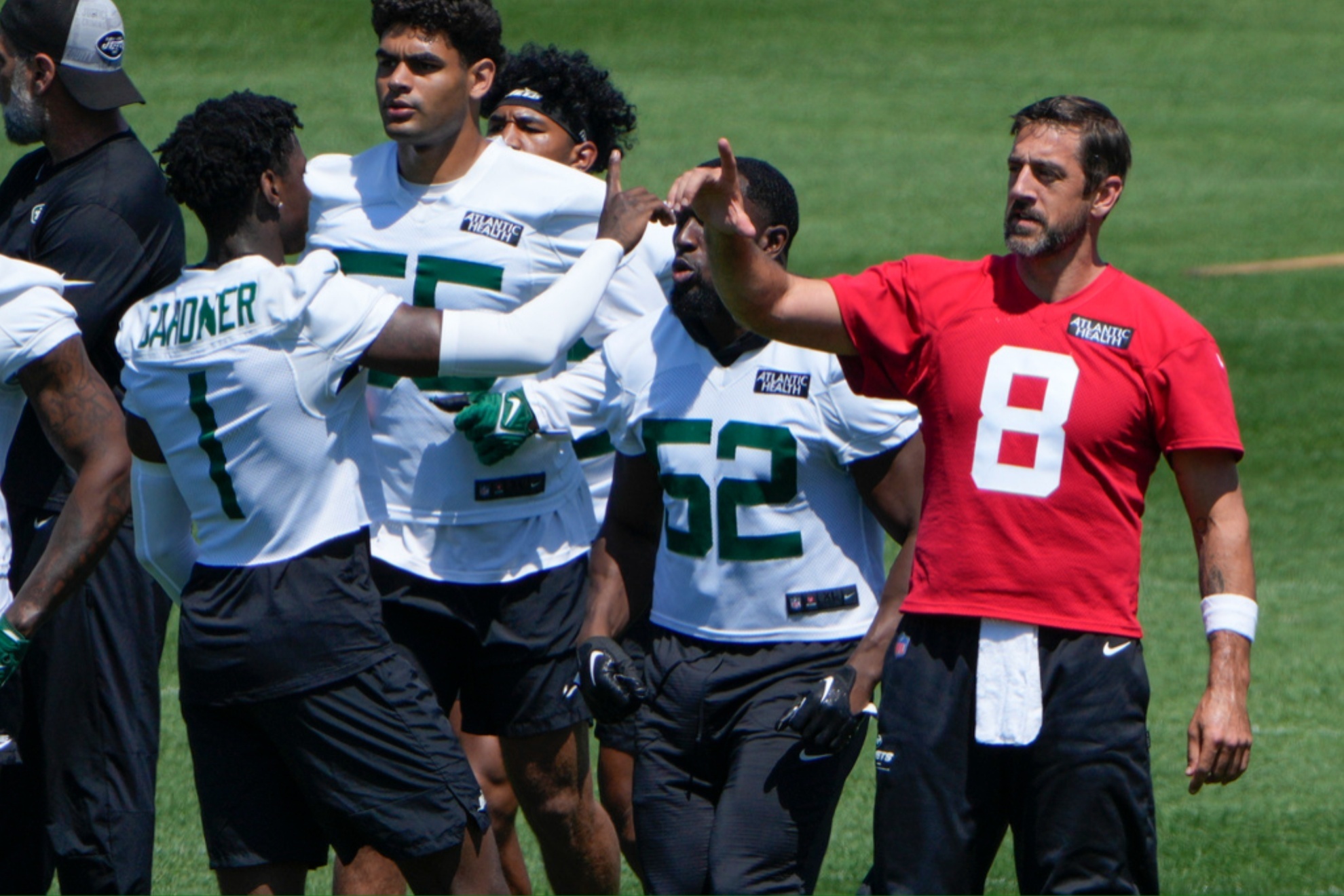 Aaron Rodgers with New York teammates during May workouts