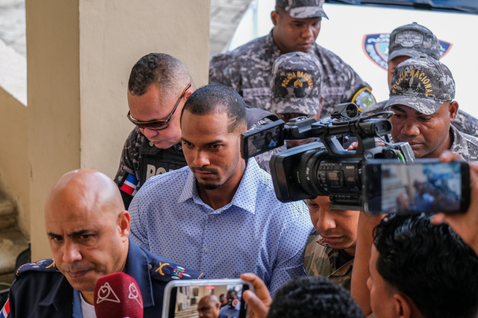 Tampa Bay Rays shortstop Wander Franco, center, is escorted by police to court in Puerto Plata