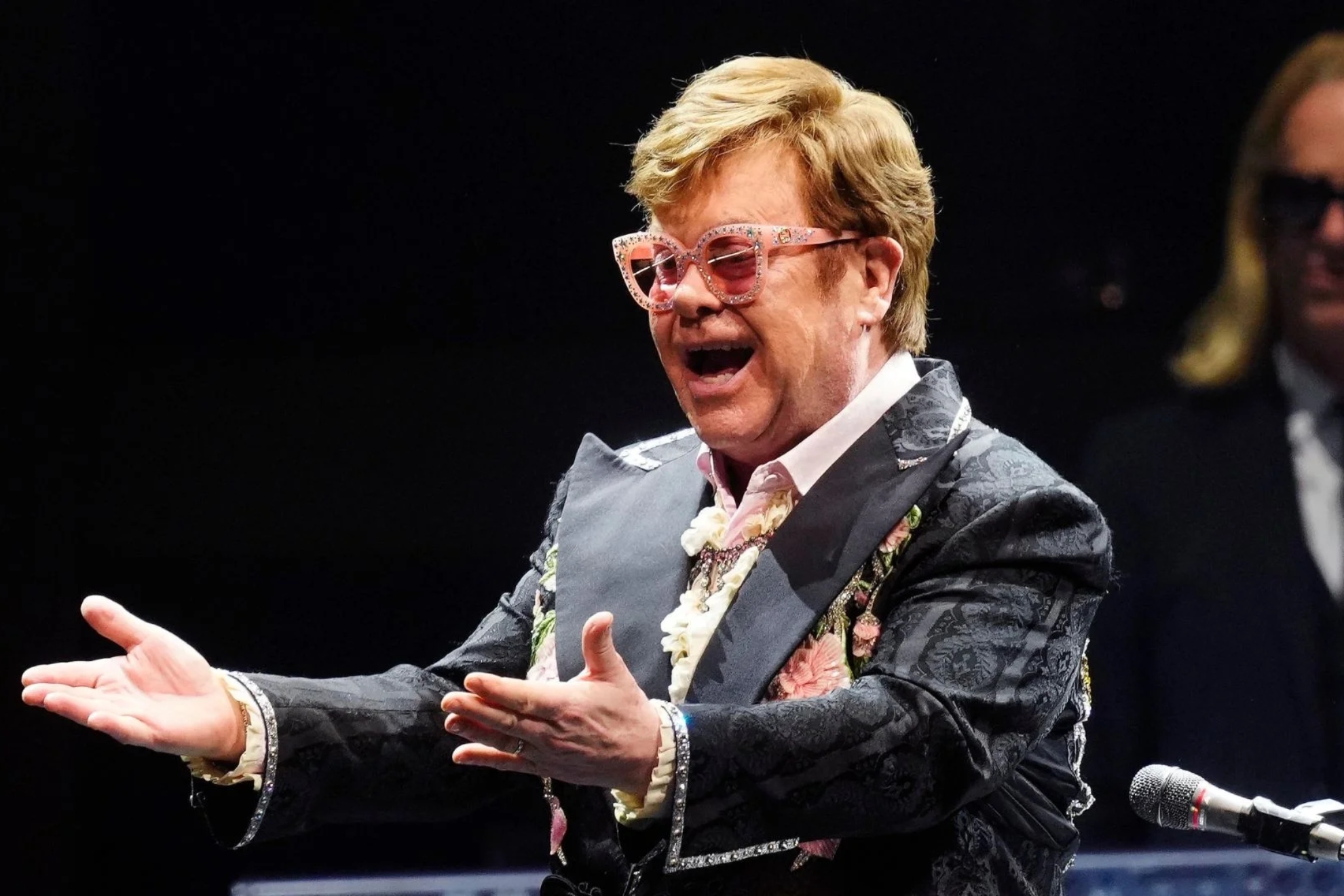 Elton John urinates into a bottle in a luxury shop in France