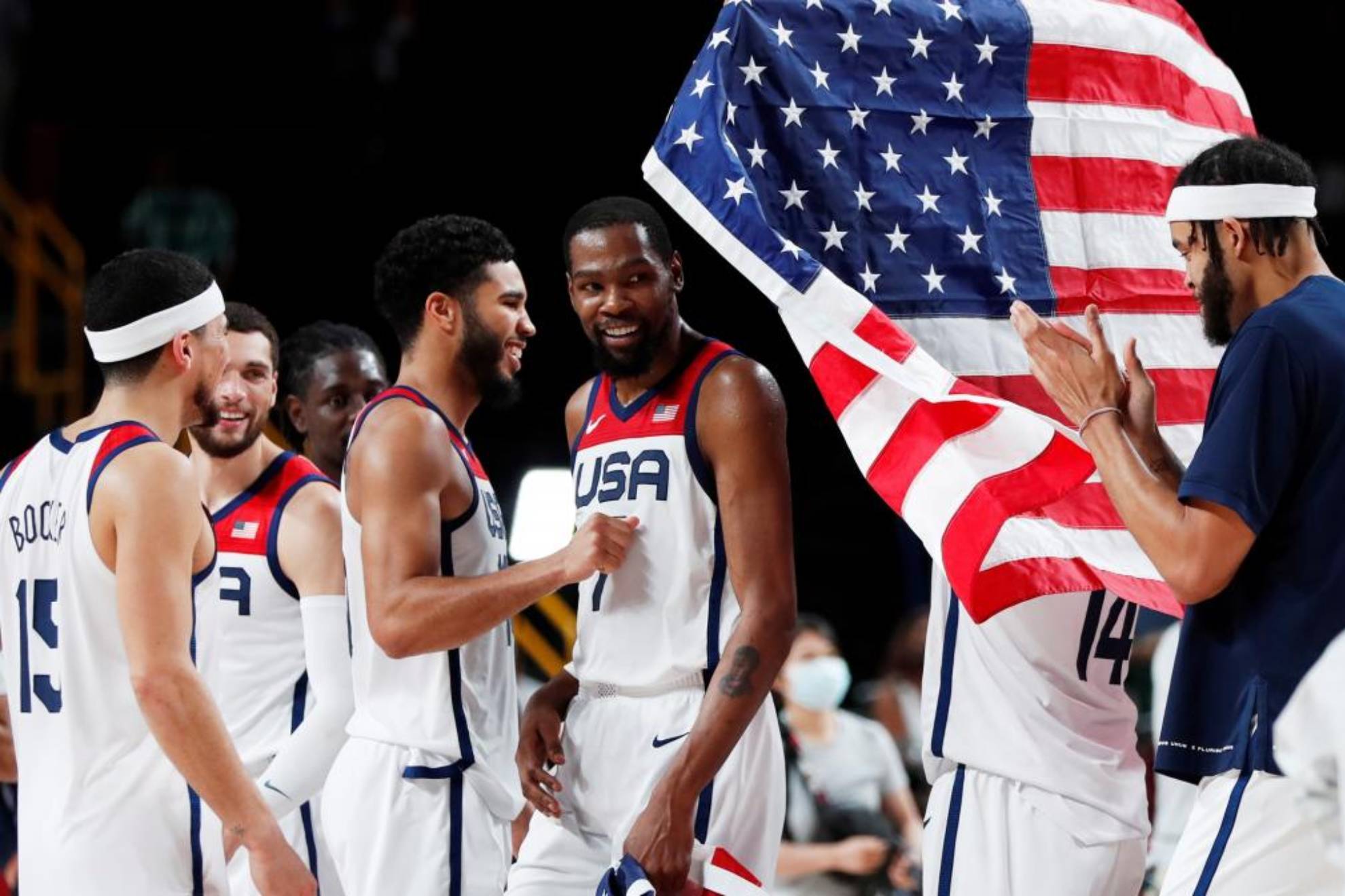 Durant walks past the U.S. flag during the Tokyo Olympics.