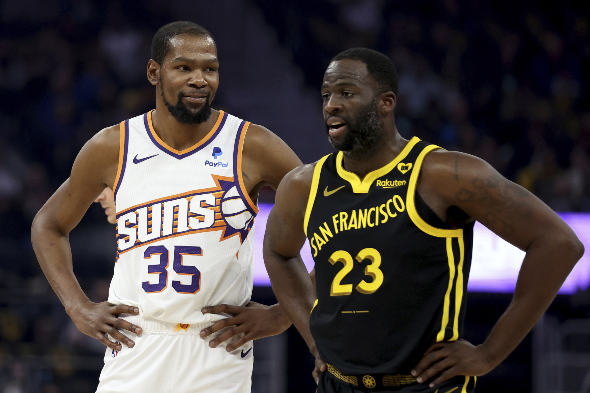 Phoenix Suns forward Kevin Durant (35) speaks with Golden State Warriors forward Draymond Green (23)