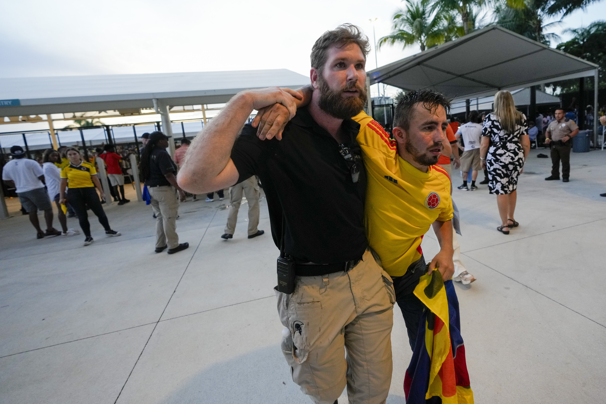 An injured Colombia fan is dragged away.