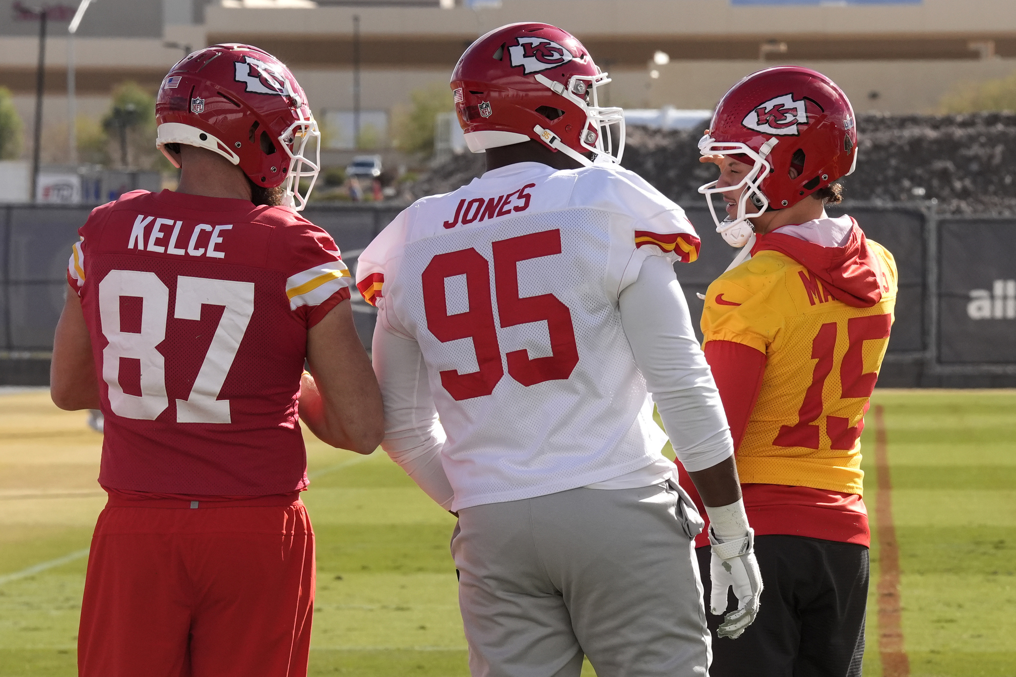 Kansas City Chiefs tight end Travis Kelce (87), defensive tackle Chris Jones (95) and quarterback Patrick Mahomes (15) talk during practice for Super Bowl 58