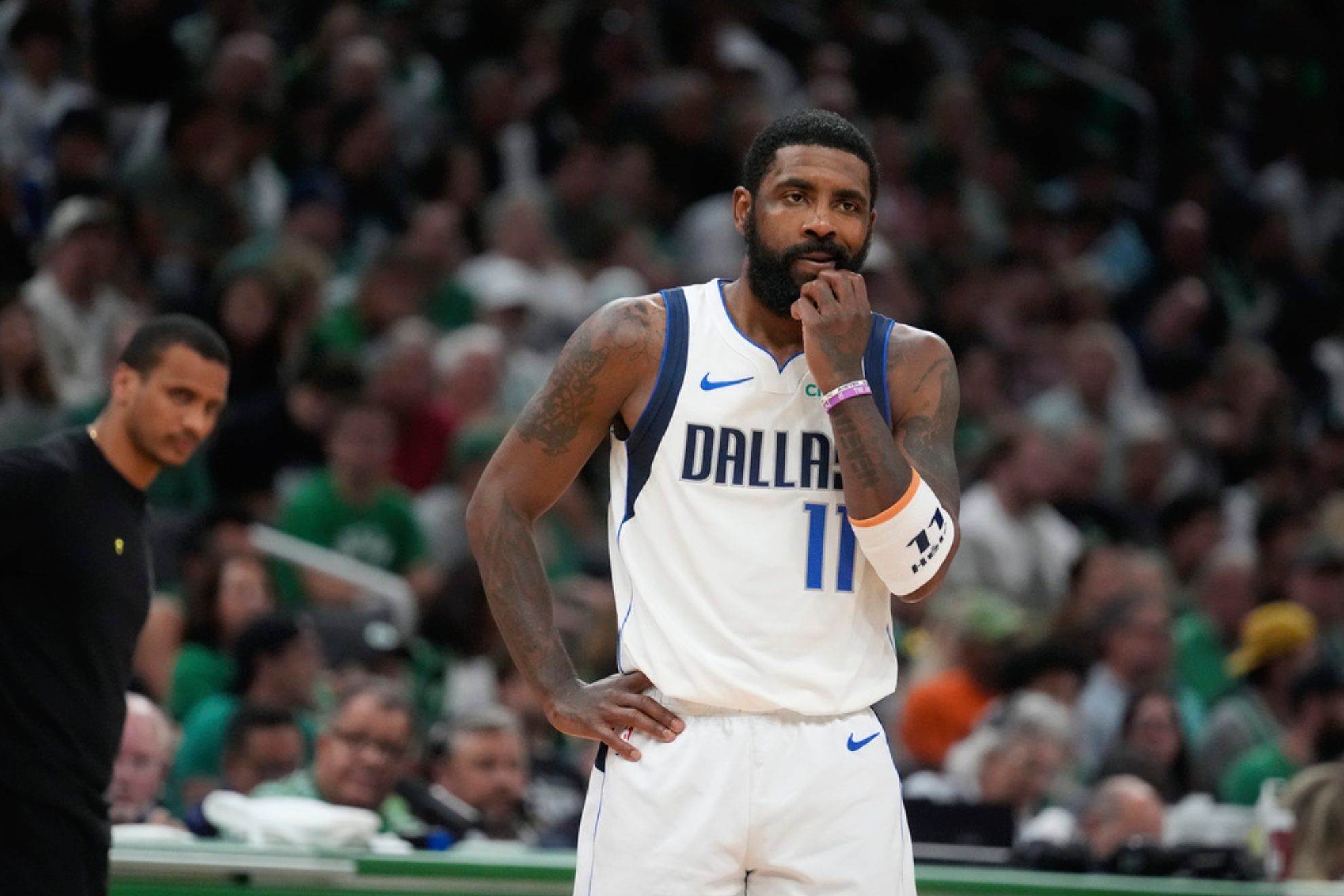 Dallas Mavericks guard Kyrie Irving pauses on the court in front of Boston Celtics head coach Joe Mazzulla