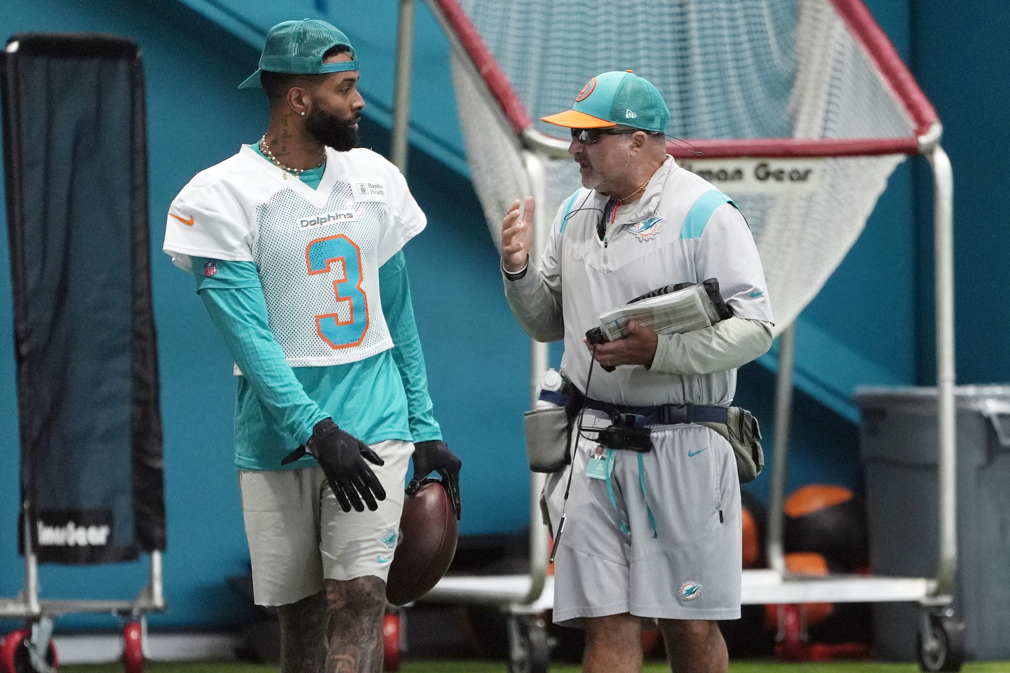 Miami Dolphins wide receiver Odell Beckham Jr. talks to an assistant coach