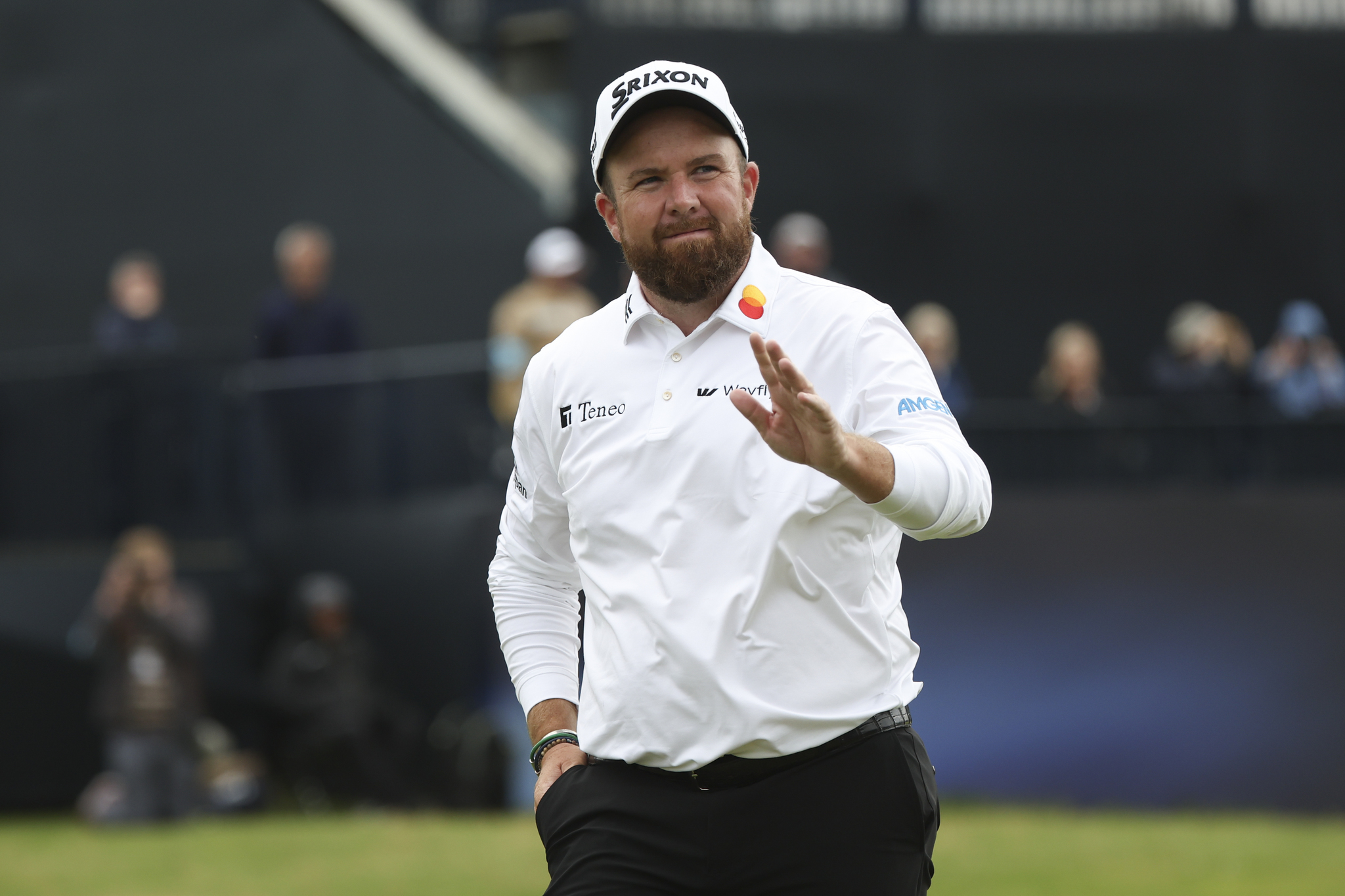 Shane Lowry waves as he walks from the 18th green