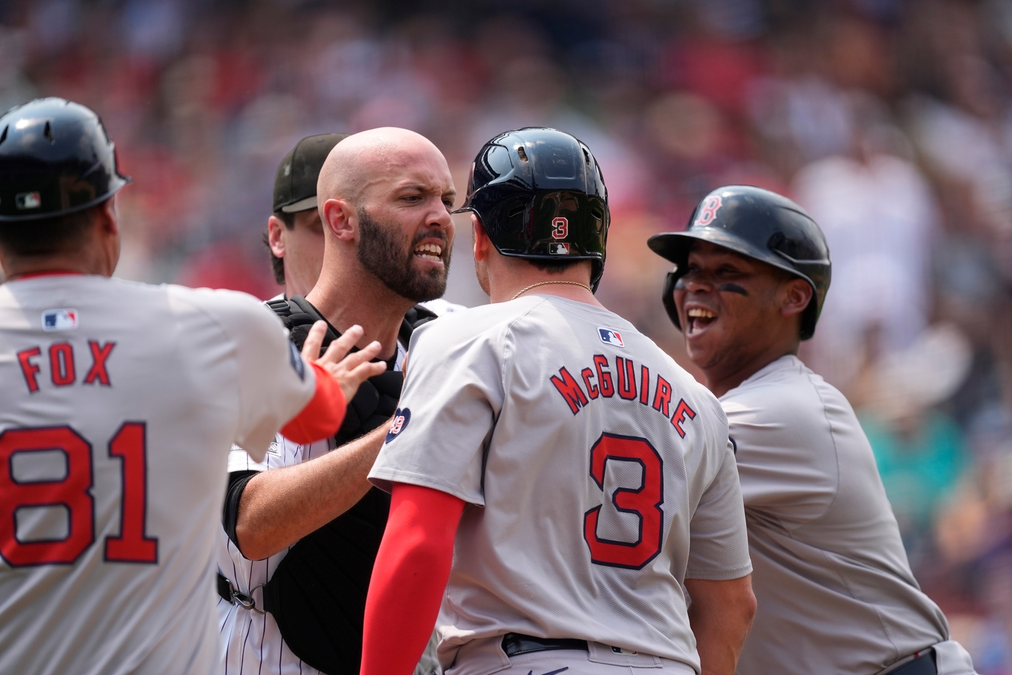 Colorado Rockies catcher Jacob Stallings protects starting pitcher Cal Quantrill after he got into a verbal altercation with Boston Red Soxs Reese McGuire