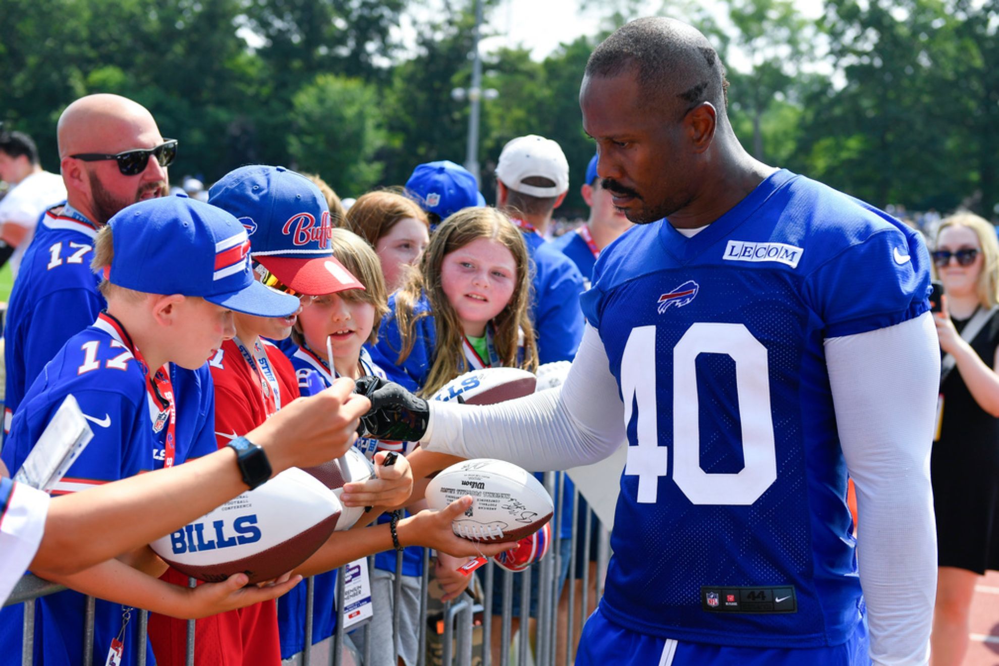 Von Miller signs autographs after an NFL football training camp practice /