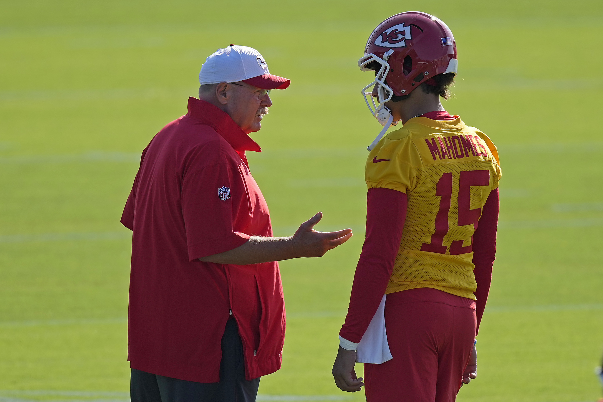 Kansas City Chiefs head coach Andy Reid talks to quarterback Patrick Mahomes (15) during NFL football training camp