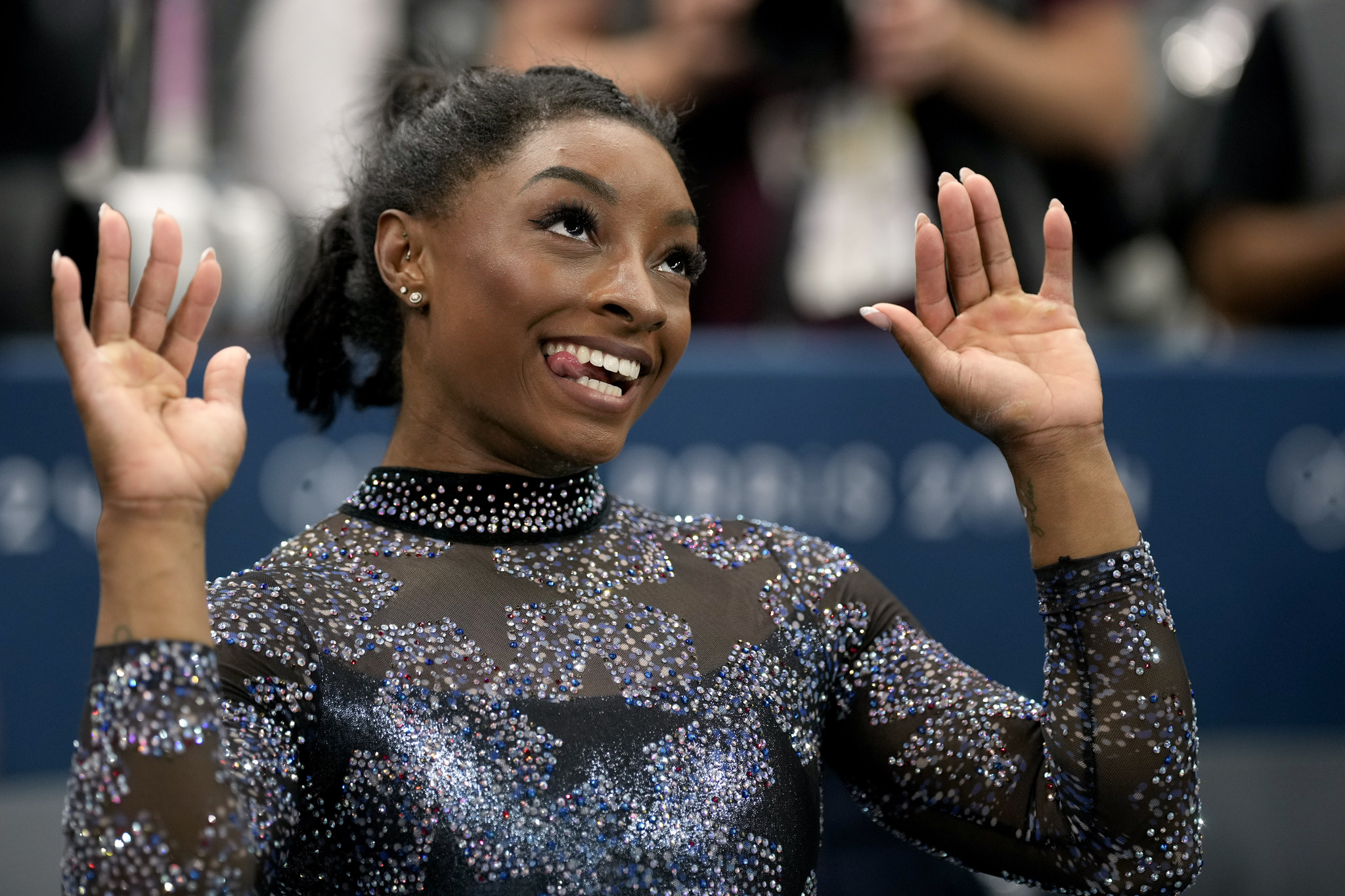 Simone lt;HIT gt;Biles lt;/HIT gt;, of United States, celebrates after competing on the uneven bars during a womens artistic gymnastics qualification round at Bercy Arena at the 2024 Summer Olympics, Sunday, July 28, 2024, in Paris, France. (AP Photo/Charlie Riedel)