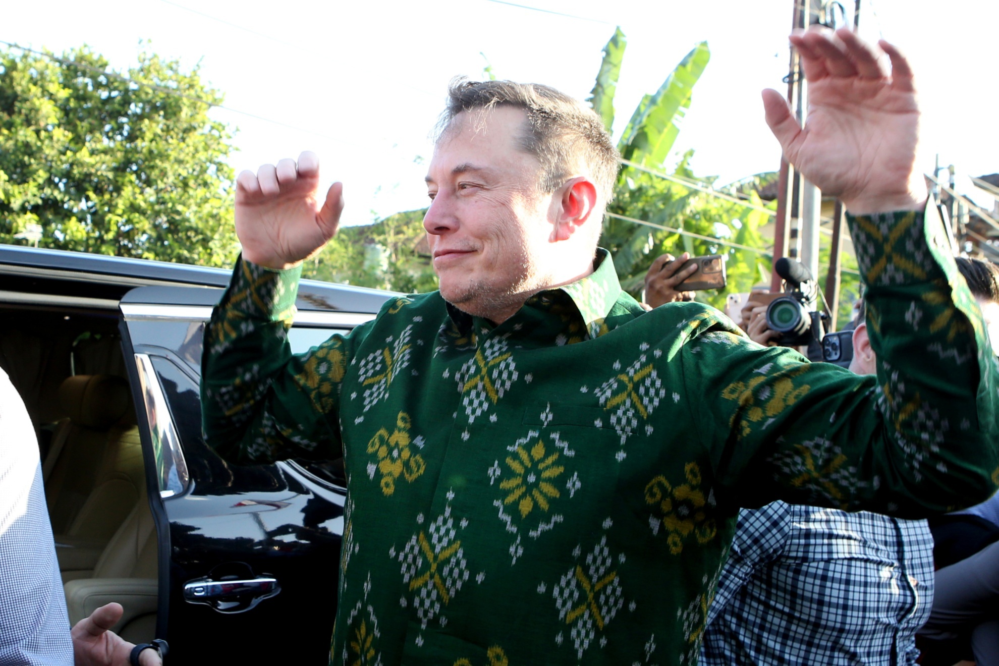 Elon Musk gesture upon his arrival at a public health center at Denpasar, Bali, Indonesia, on Sunday, May 19, 2024. Elon Musk arrived in Indonesias resort island of Bali to launch Starlink satellite internet service in the worlds largest archipelago nation. (AP Photo/Firdia Lisnawati)