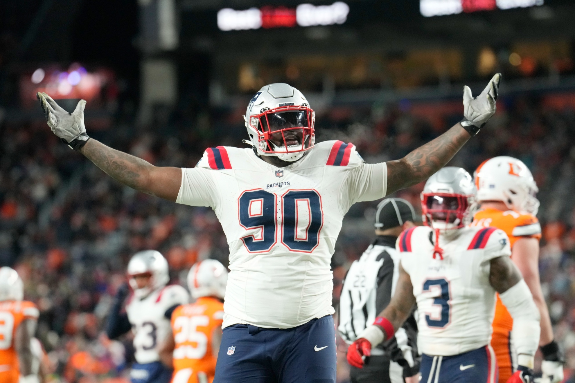 New England Patriots defensive tackle Christian Barmore (90) reacts after a play during the second half of an NFL football game against the Denver Broncos, Sunday, Dec. 24, 2023, in Denver. New England Patriots defensive tackle Christian Barmore has agreed to a four-year contract extension worth up to $92 million, according to a person with knowledge of the deal. The person confirmed the deal to The Associated Press on the condition of anonymity on Monday, April 29, 2024, because it has not been announced.(AP Photo/David Zalubowski, File)