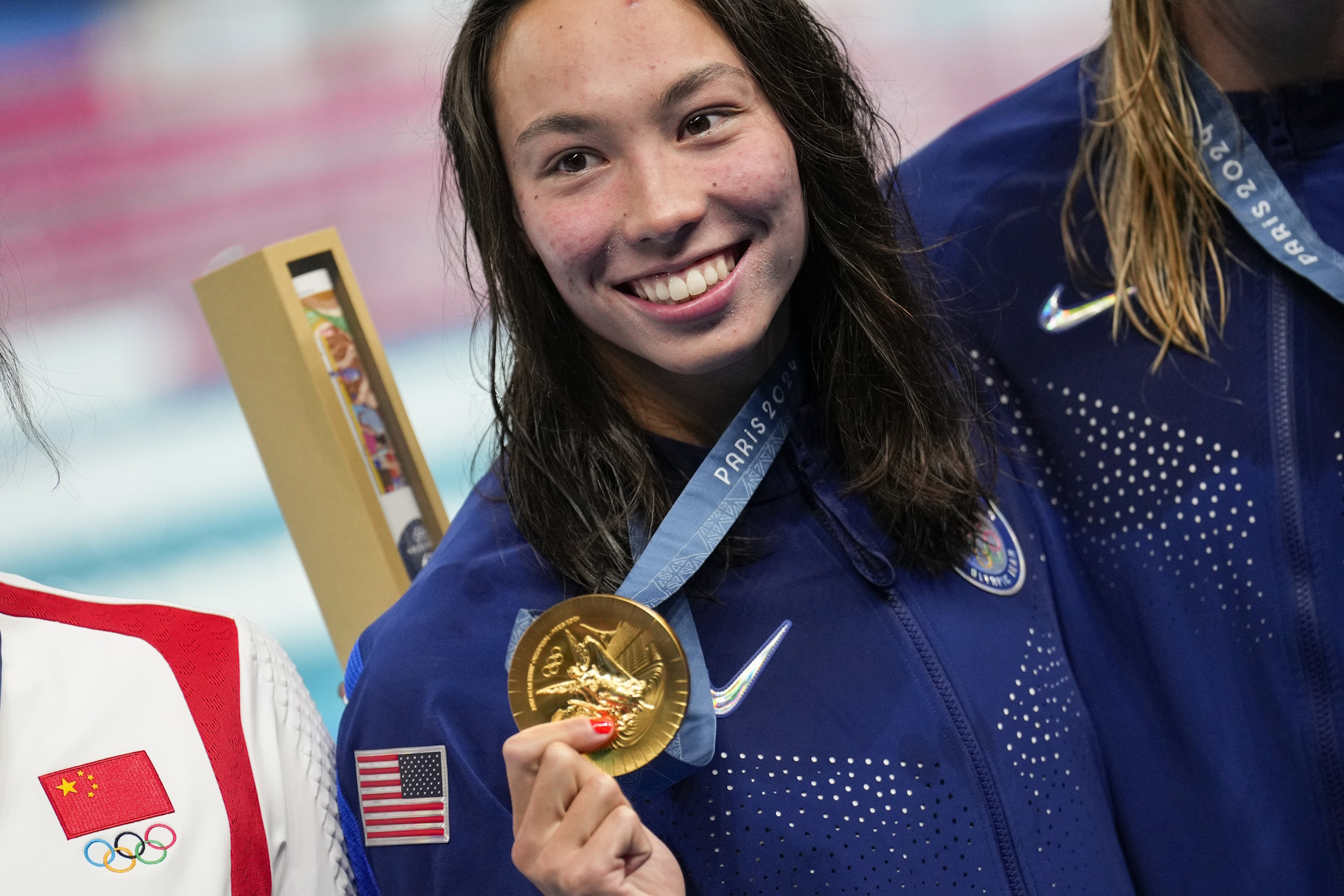 Gold medalist, Torri Huske, of the United States, poses after the womens 100-meter butterfly final at the 2024 Summer Olympics.