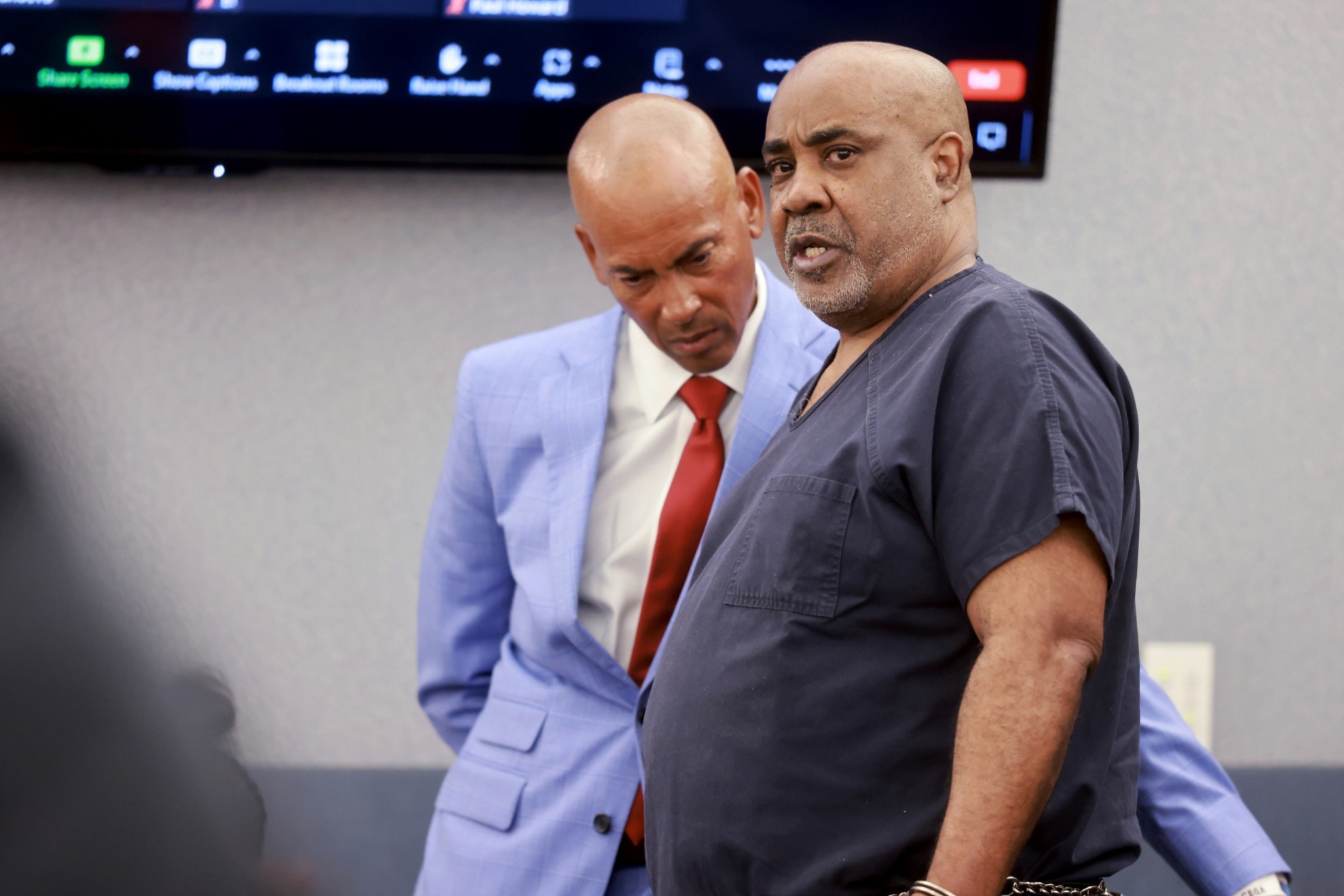 Duane Keffe D Davis, who is accused of orchestrating the 1996 slaying of hip-hop icon Tupac Shakur, right, talks to his attorney, Carl Arnold, in court at the Regional Justice Center in Las Vegas, Tuesday, June 25, 2024. (K.M. Cannon/Las Vegas Review-Journal via AP, Pool)