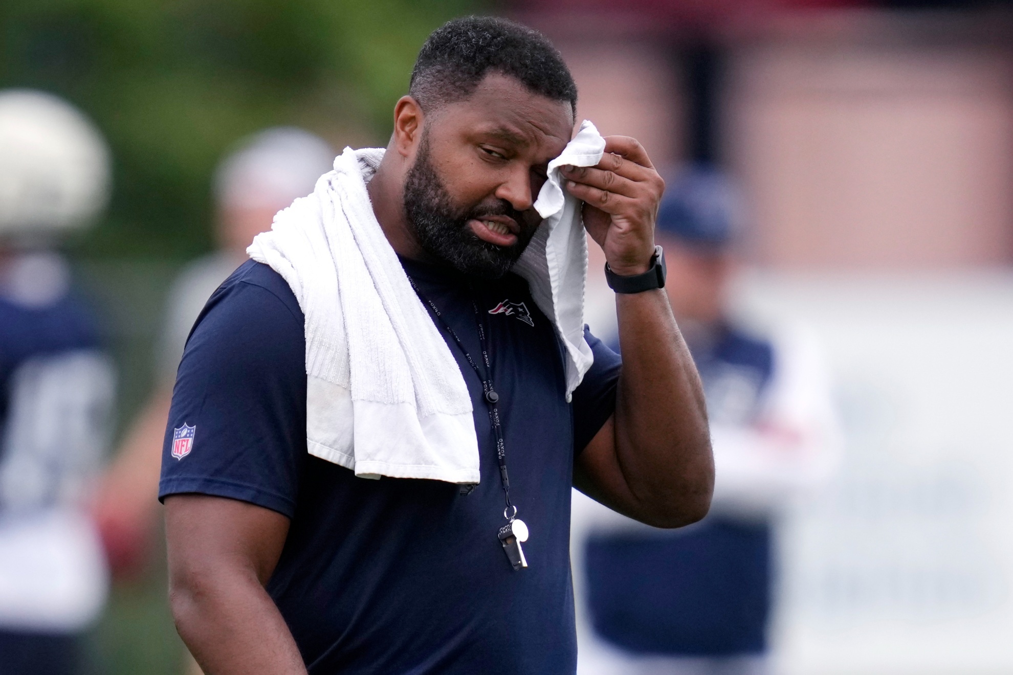 New England Patriots head coach Jerod Mayo wipes his brow during an NFL football training camp, Thursday, July 25, 2024, in Foxborough, Mass. (AP Photo/Charles Krupa)