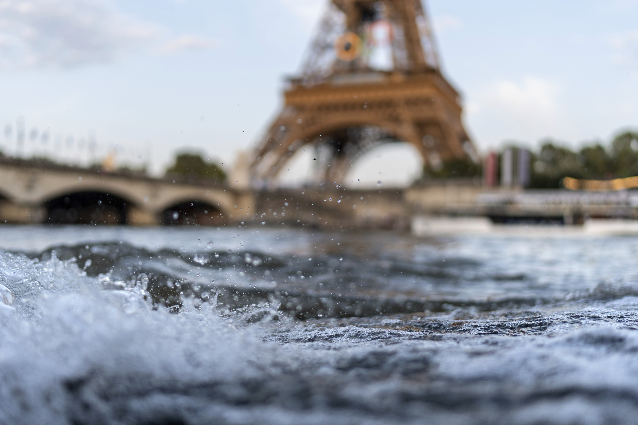 Waves crash along the banks of the Seine River in front of the  lt;HIT gt;Eiffel lt;/HIT gt;  lt;HIT gt;Tower lt;/HIT gt; during the 2024 Summer Olympics, Monday, July 29, 2024, in Paris. As the Olympics continue in Paris, the Seine River's water quality remains a major area of concern for officials. Organizers of the triathlon event cancelled swimming practice on Monday for the second day in a row because of poor water quality. Event organizers hope sunny weather will make swimming viable on Tuesday when the triathlon begins. (AP Photo/David Goldman)