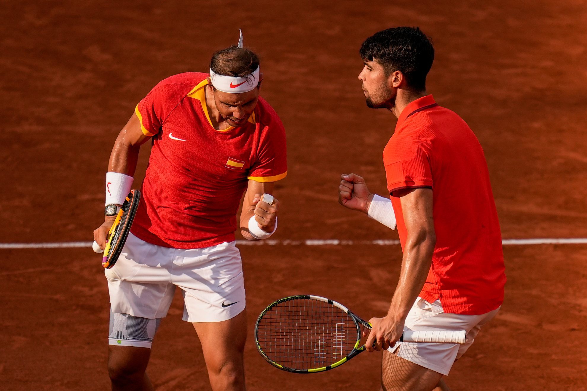 Carlos Alcaraz and Rafael Nadal celebrate a point against Tallon Griekspoor and Wesley Koolhof of the Netherlands