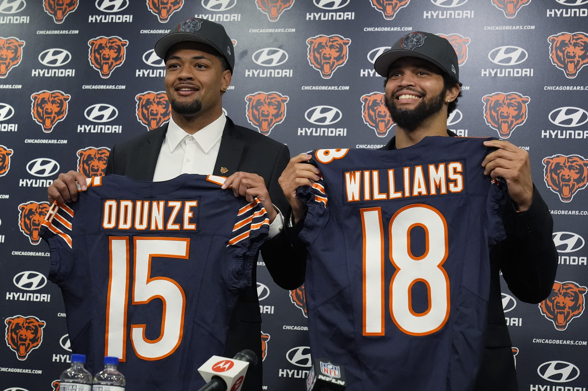 Chicago Bears No. 9 draft pick wide receiver Rome Odunze, left, and No. 1 draft pick quarterback Caleb Williams, right, hold up jerseys