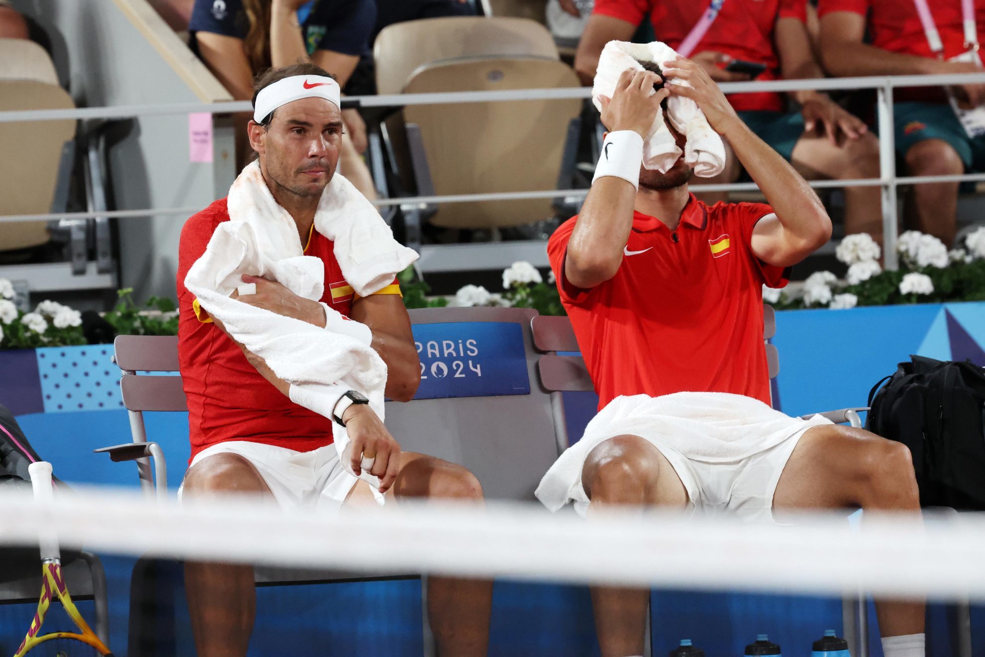 Carlos Alcaraz and Rafael Nadal of Spain rest during the Mens Doubles Quarter-final match against Austin Krajicek and Rajeev Ram /