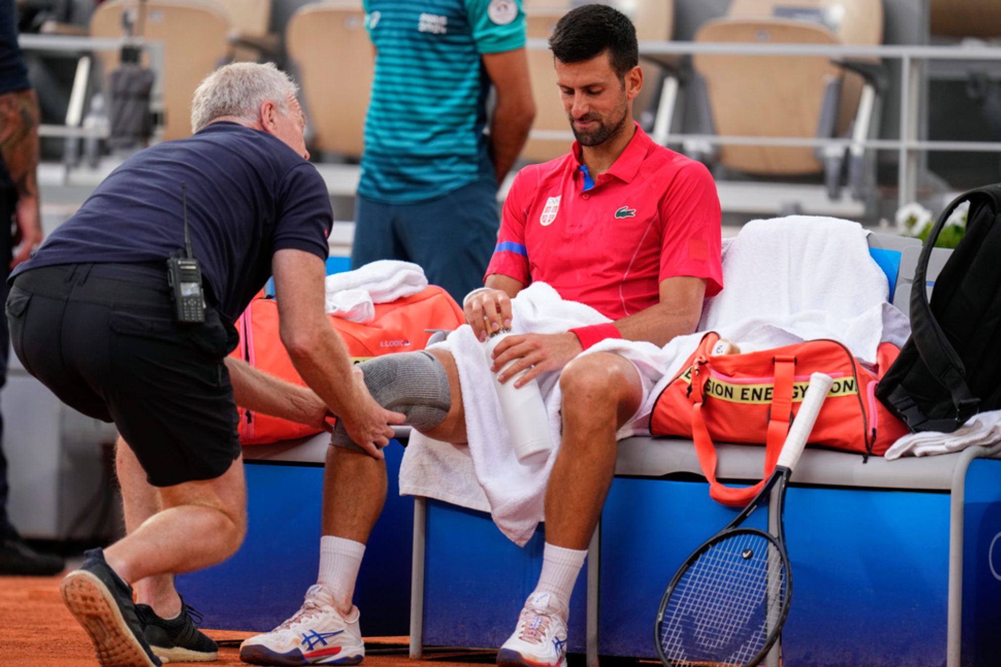 Novak Djokovic receives medical treatment during his match against against Stefanos Tsitsipas /