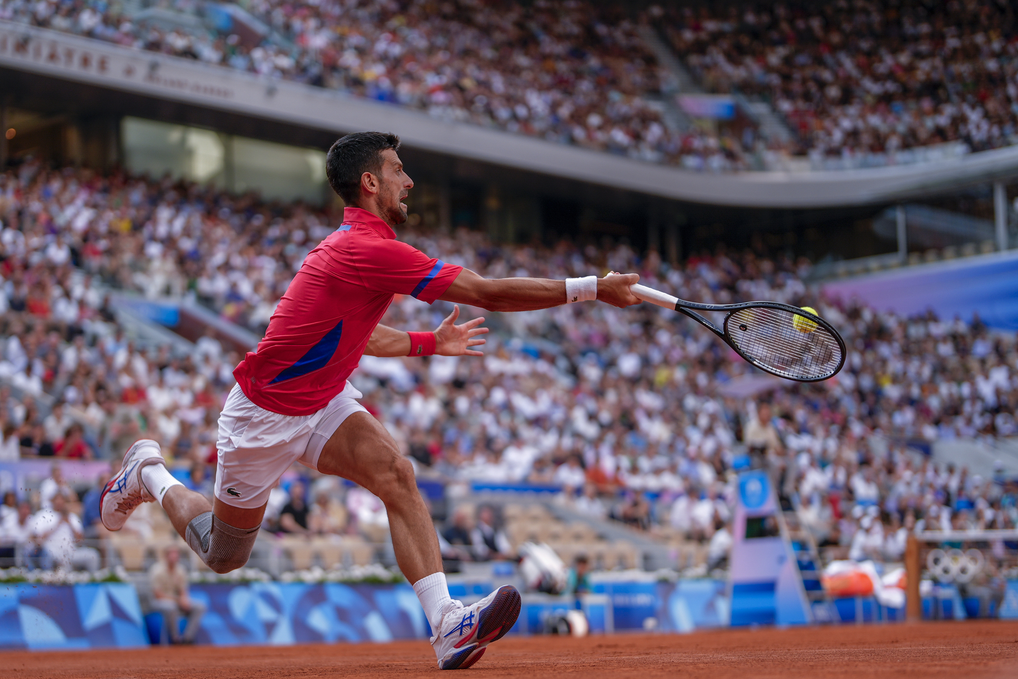 Serbias Novak lt;HIT gt;Djokovic lt;/HIT gt; returns the ball against Stefanos Tsitsipas of Greece during their mens quarter-final match at the Roland Garros stadium, at the 2024 Summer Olympics, Thursday, Aug. 1, 2024, in Paris, France. (AP Photo/Manu Fernandez)