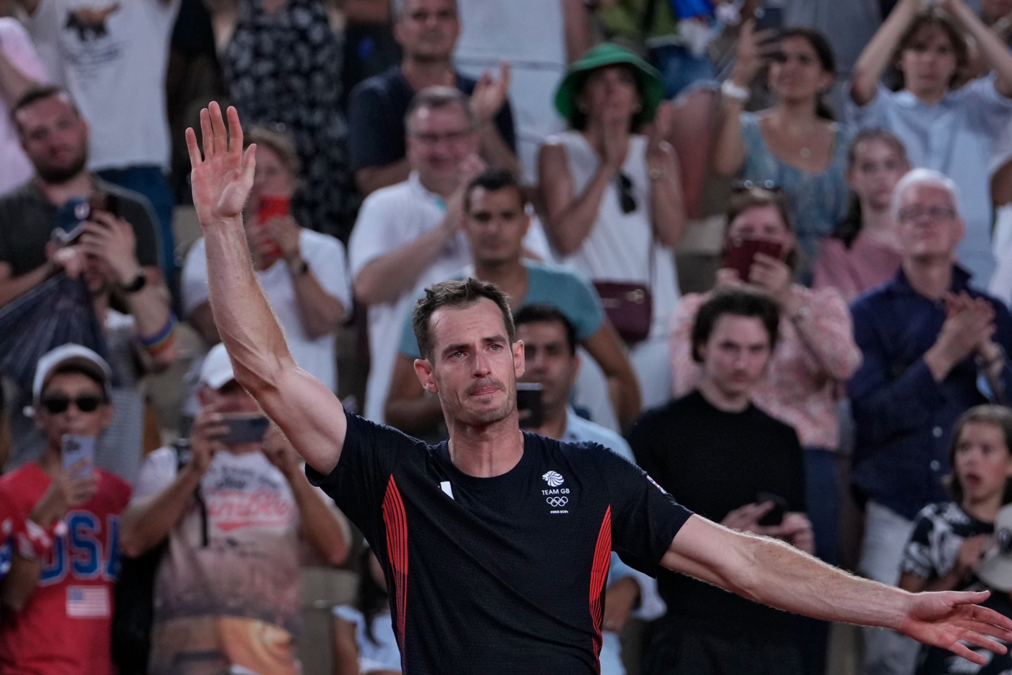 Andy Murray of Britain cries as he waves to the spectators after he and his partner Daniel Evans lost the mens doubles quarterfinals tennis match to Taylor Fritz and Tommy Paul of the United States, at the 2024 Summer Olympics, Thursday, Aug.1, 2024, at the Roland Garros stadium in Paris, France. (AP Photo/Andy Wong)