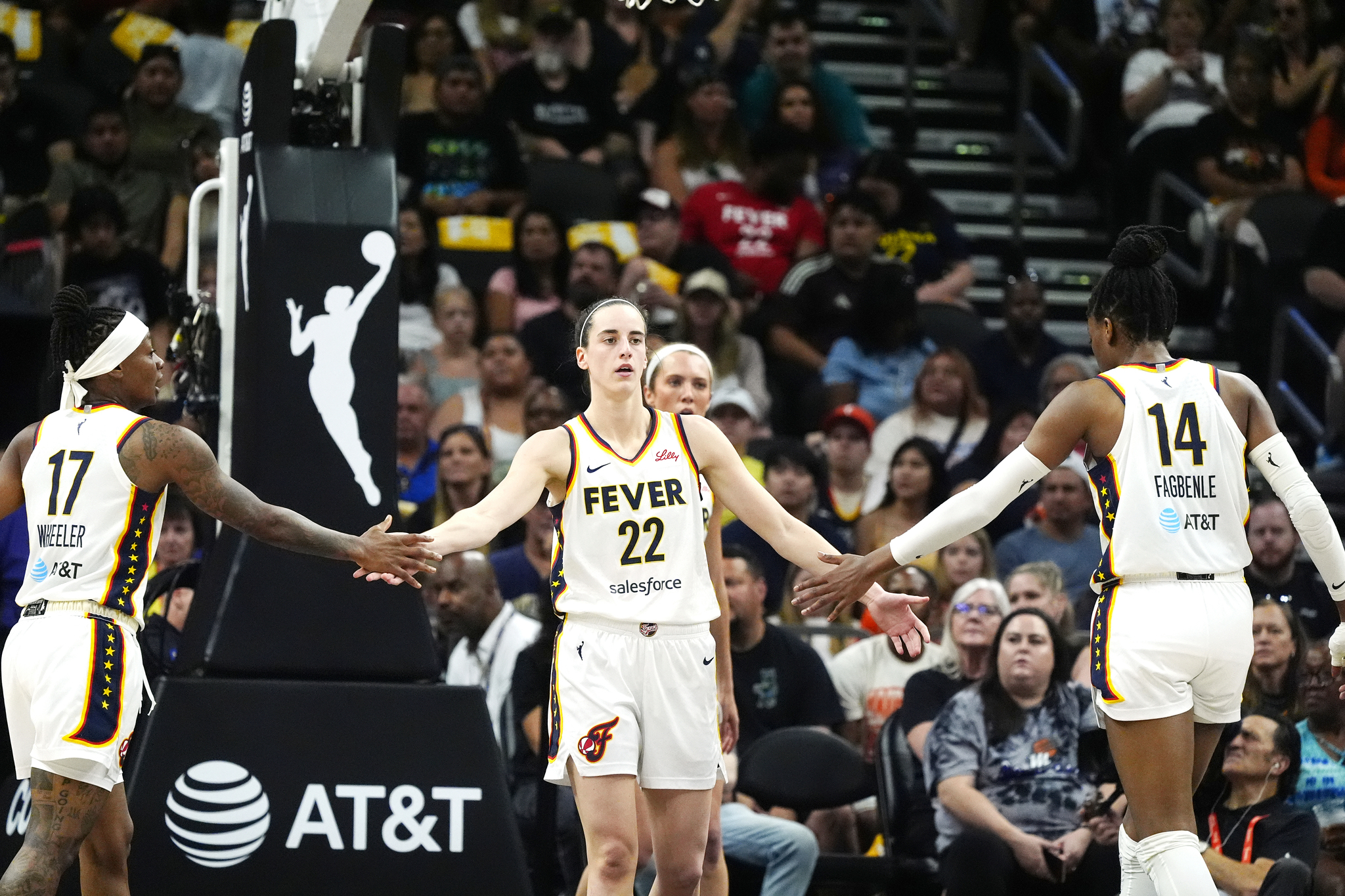 Indiana Fever guard Caitlin Clark (22) is congratulated by Fever guard Erica Wheeler (17) and Fever center Temi Fagbenle (14)