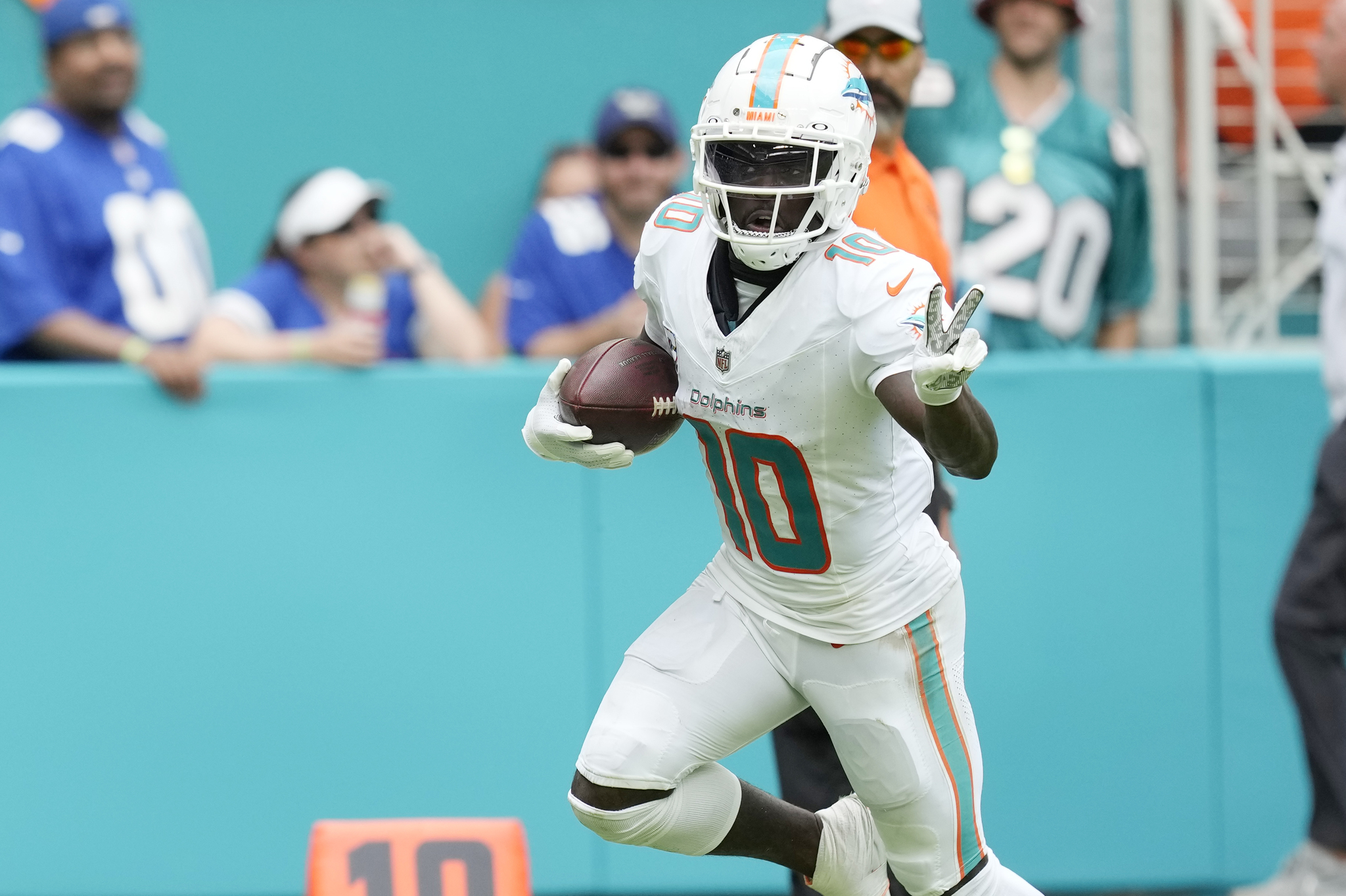 Miami Dolphins wide receiver Tyreek Hill (10) gestures as he runs for a touchdown