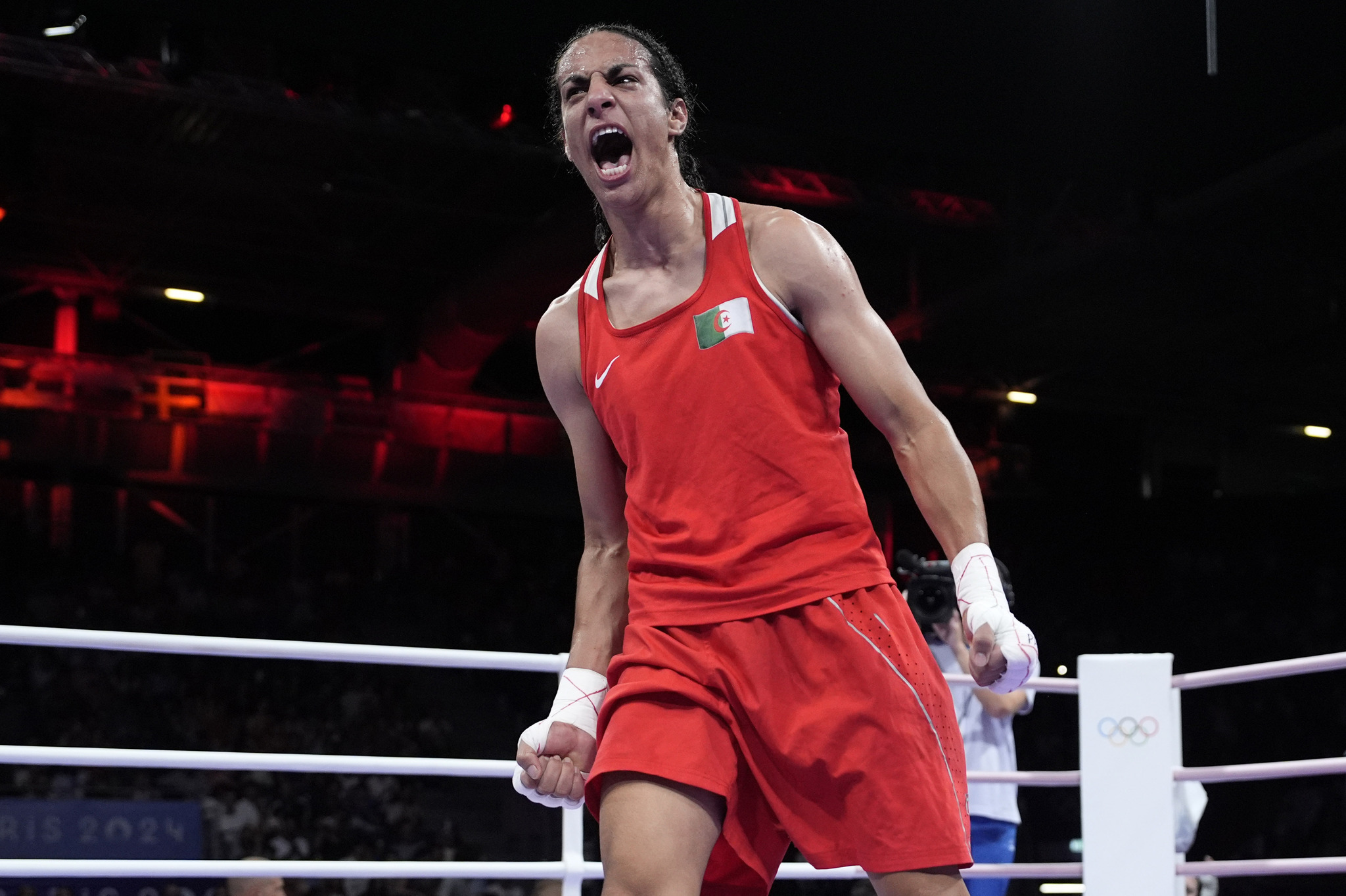 Algerias Imane Khelif celebrates after defeating Hungarys Anna Hamori