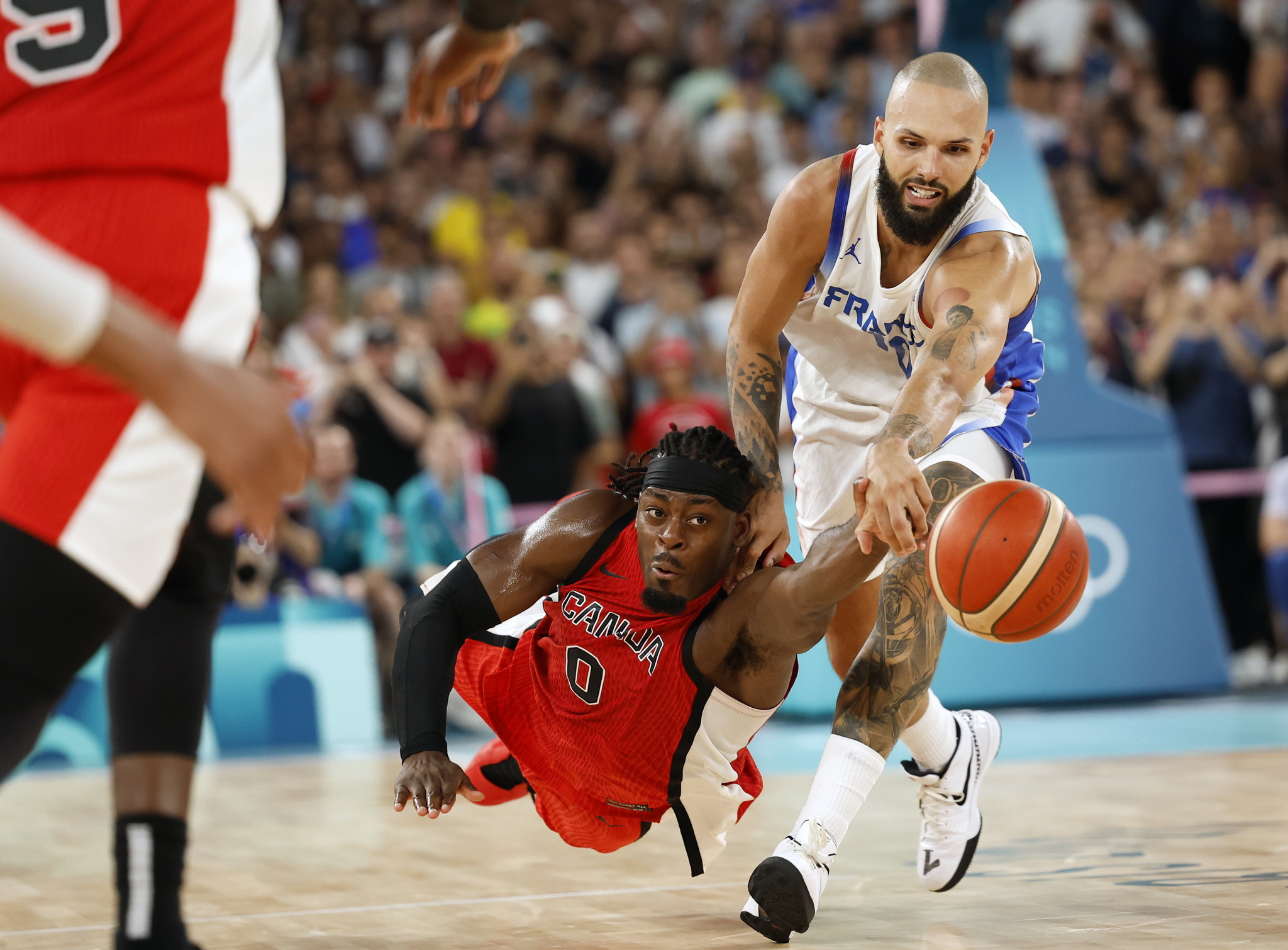 Luguentz Dort of Canada in action against Evan Fournier of France