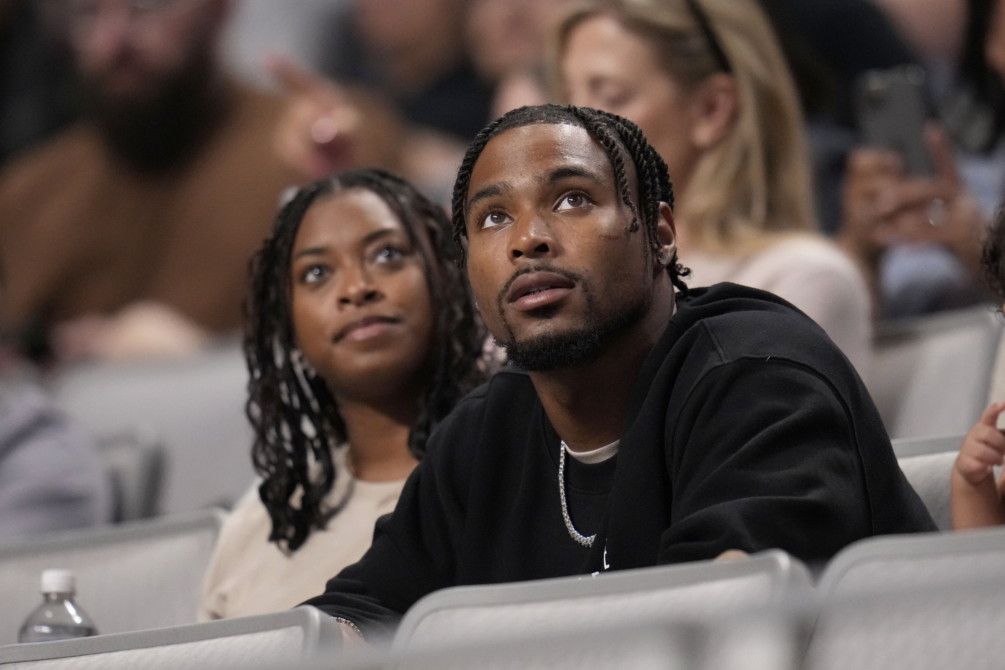 Jonathan Owens, the husband of Simone Biles watches as she competes on the balance beam