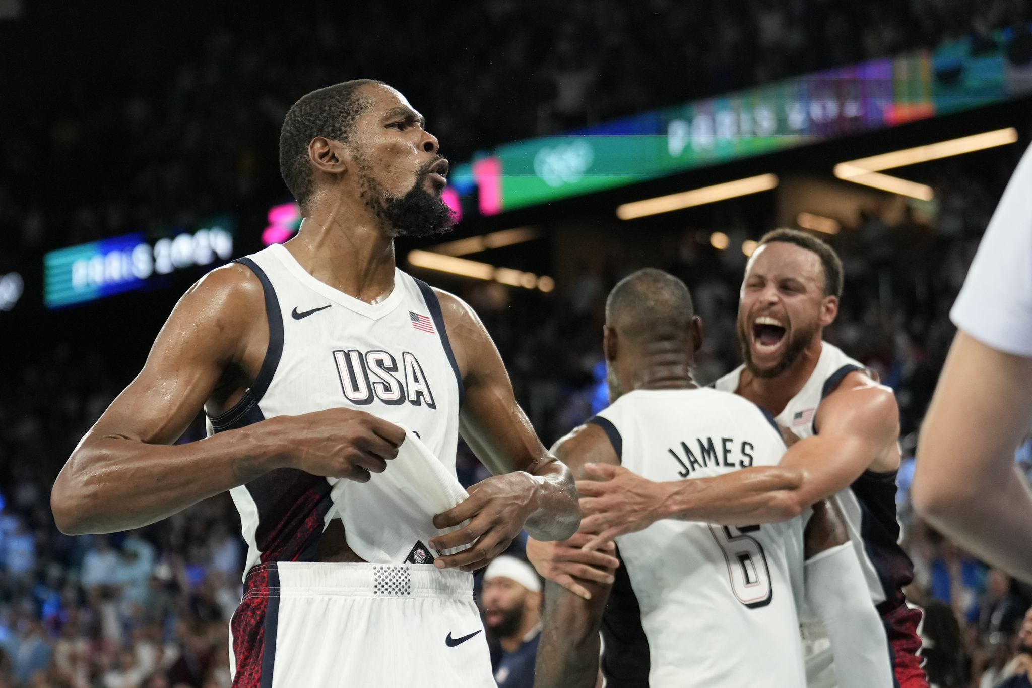 United States Kevin Durant (7), LeBron James (6) and Steph Curry (4) celebrate after beating Serbia