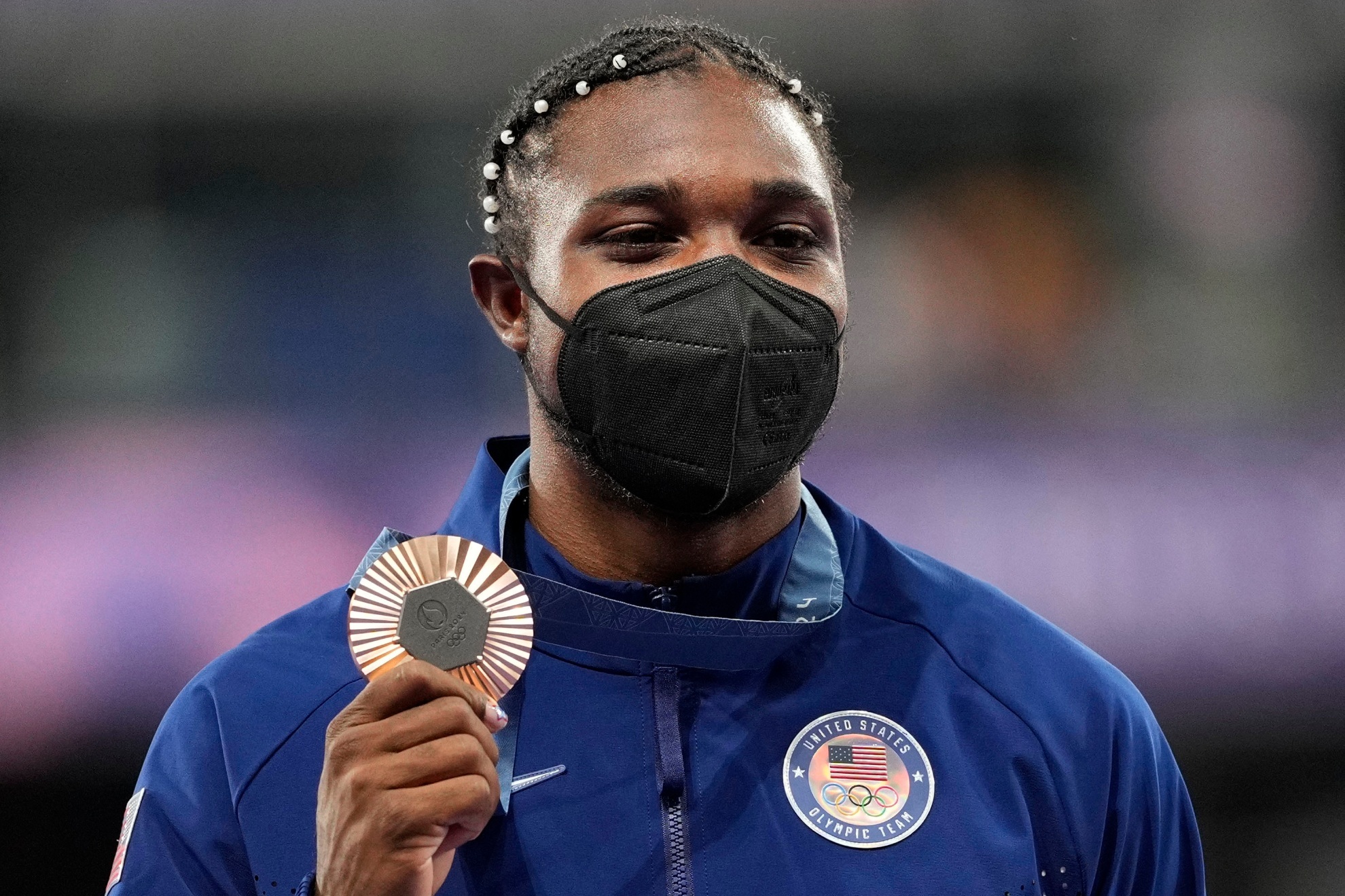 Noah Lyles holding his bronze medal