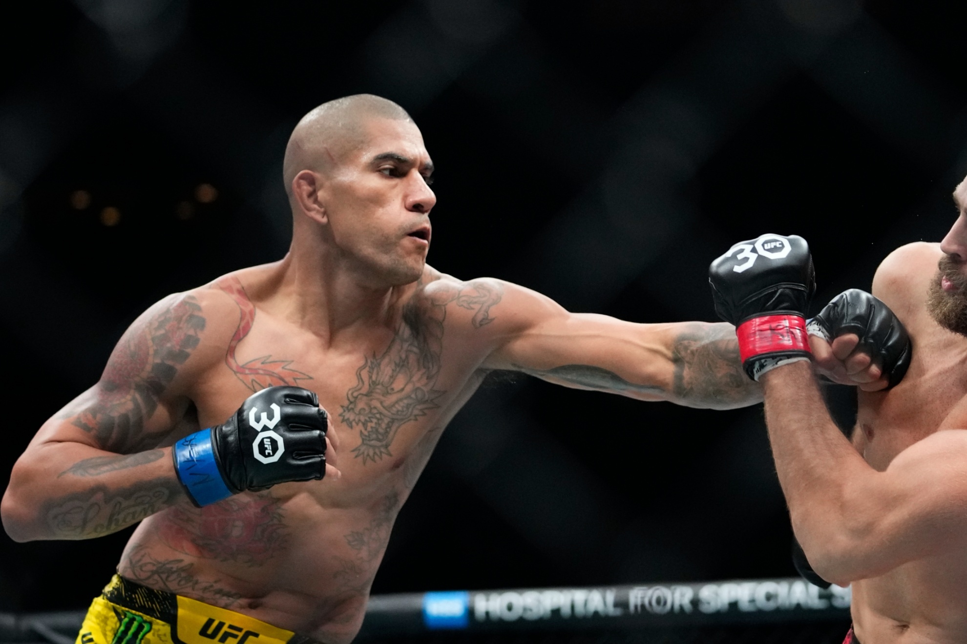 Brazils Alex Pereira, left, punches Czech Republics Jir� Proch�zka during the second round of a light heavyweight title bout at the UFC 295 mixed martial arts event ealry Sunday, Nov. 12, 2023, in New York. (AP Photo/Frank Franklin II)