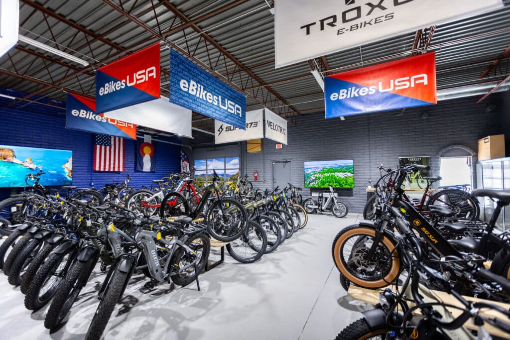 Image show eBikes USA showroom with a broad selection of eBike brands and banners showcasing the brands available