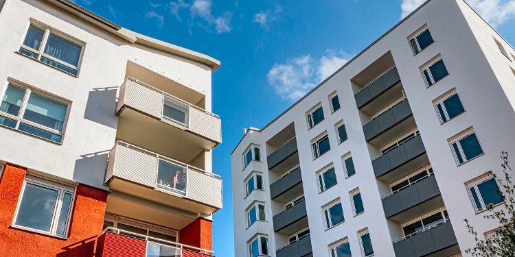 Two residential buildings with clear blue sky above