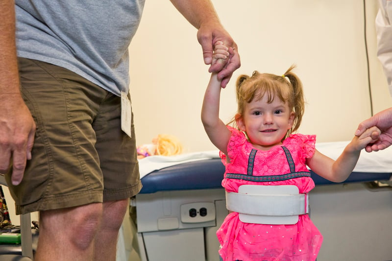 little girl with back brace