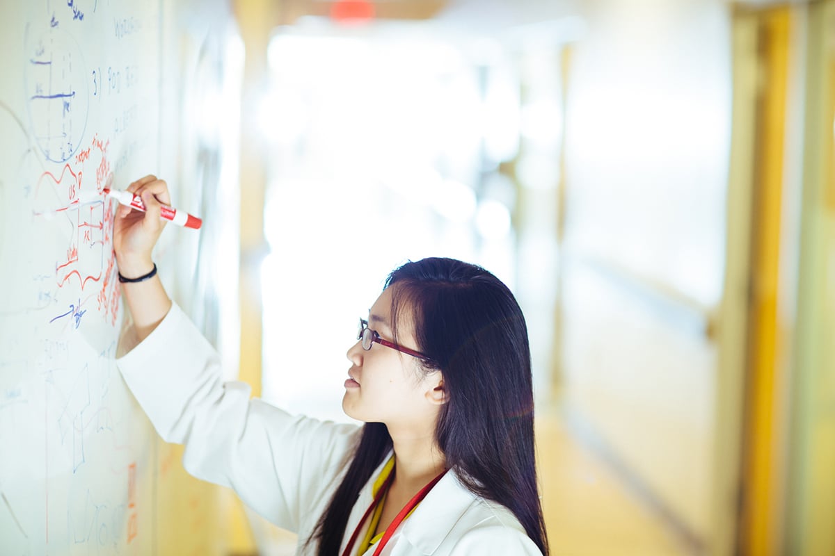 physician writing on white board