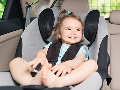 baby girl buckled in a forward-facing car seat