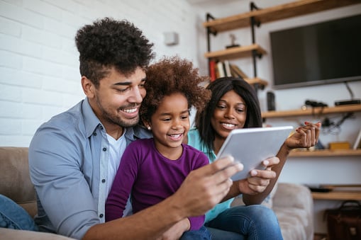 Family looking an an iPad