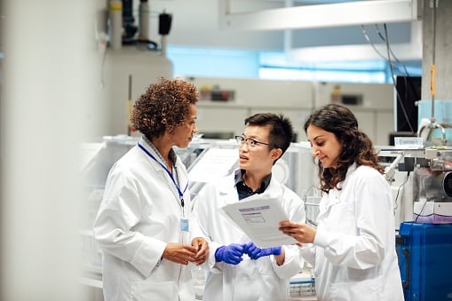 A group of doctors standing together talking. 