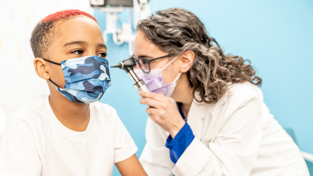 doctor examines young boy