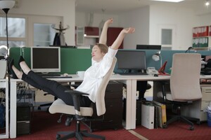 business woman resting, with her feet up on her desk