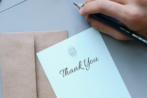 wedding thank you note on top of brown envelope