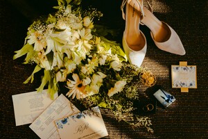 wedding shoes, flowers, and invitations