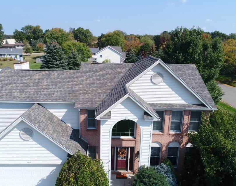 Red Brick and White Siding Home with Asphalt Roof, Cornerstone