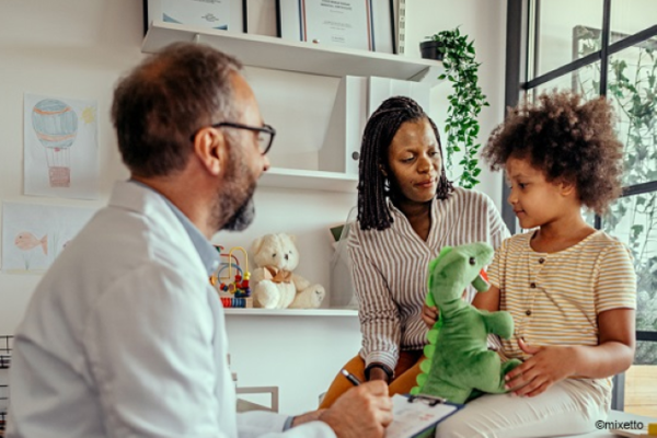 Doctor assessing a mother and child