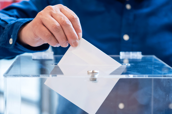 Men in blue shirt voting