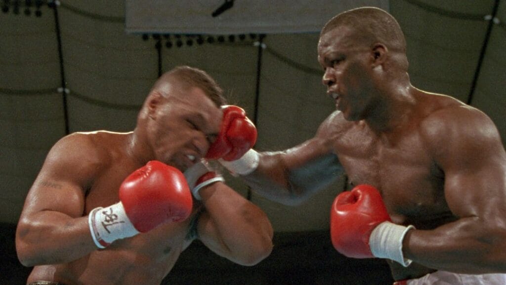 James "Buster" Douglas, right, hits Mike Tyson with a hard right in the face during their world heavyweight title bout.