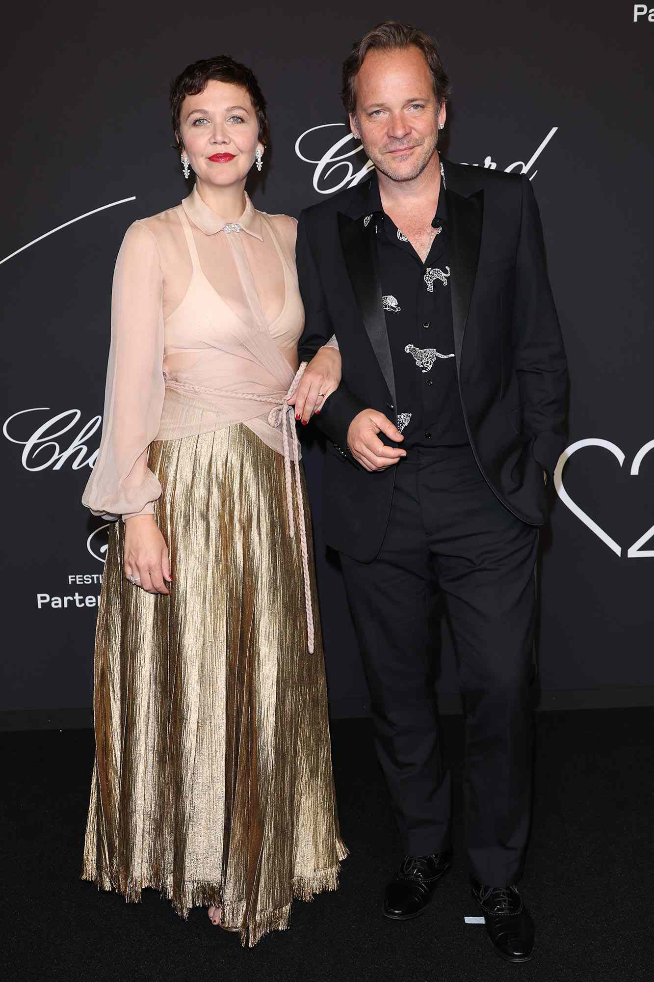 Maggie Gyllenhaal and Peter Sarsgaard attend "Chopard Loves Cinema" Gala Dinner at Hotel Martinez on May 25, 2022 in Cannes, France.